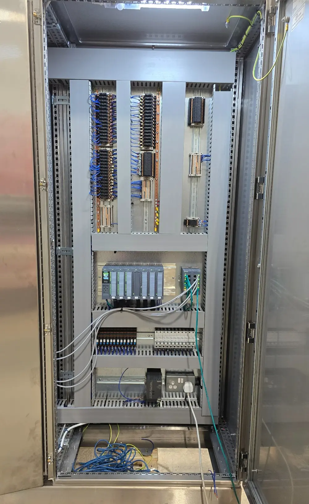 Industrial control panel internal wiring and PLC I/O during construction