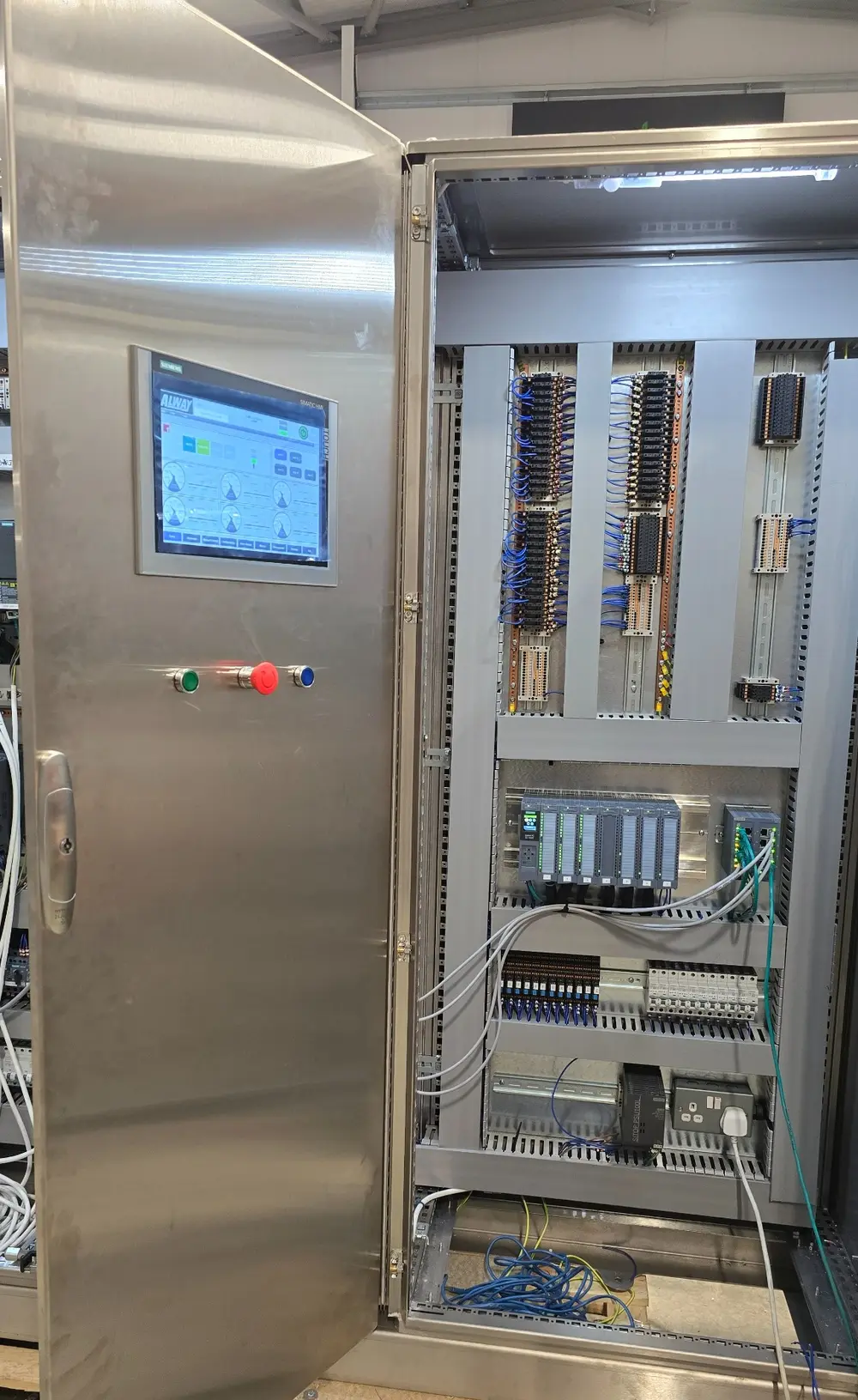 Stainless-steel industrial control panel during build and commissioning